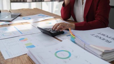 female accountant working on a tablet computer in a modern office. Make an account analysis report. real estate investment information financial and tax system concepts.
