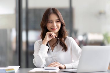 Young female work with financial papers at office count on calculator before paying taxes receipts online by phone. female employee planning budget glad to find chance for economy saving money.