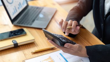female employee working on a laptop computer in a modern office. Make an account analysis report. real estate investment information financial and tax system concepts.