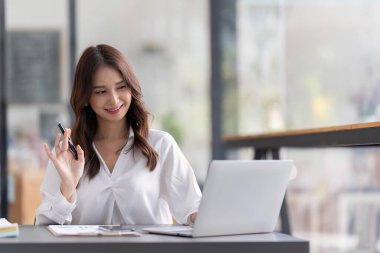 Business woman working on laptop and working at office desk at office.