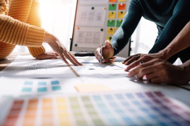 Close up view of brainstorm team of creative Web Graphic Designer ux developer and ui designer brainstorming about mobile app interface wireframe design.