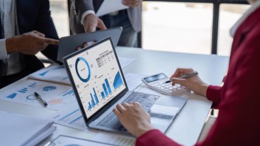 Team of business investment consultant analyzing company annual financial report working with documents pie and donut chart, using laptop and tablet, Business and Financial concept.