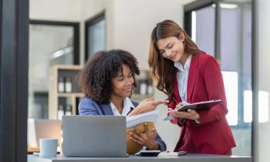 Teamwork of business people analysis graph Asian business woman advisor meeting to analyze and discuss on the financial report.