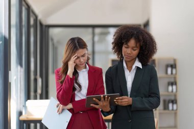 Stressed Asian business people working in the office. Business team thinking too much work concept in the office.