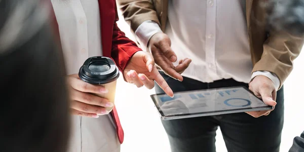 stock image Business people are meeting for analysis data figures to plan business strategy on tablet. Business discussing concept.