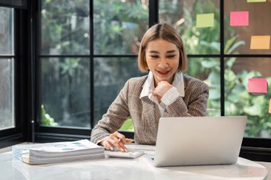 Accountant woman working on laptop and do document, tax, exchange, accounting and Financial advisor concept.
