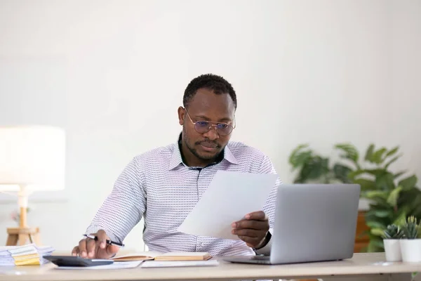 Accountant black man working on laptop and do document, tax, exchange, accounting and Financial advisor concept.