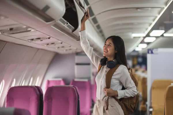 Young Asian Woman Travel Airplane Passenger Putting Hand Baggage Lockers — Stock Photo, Image