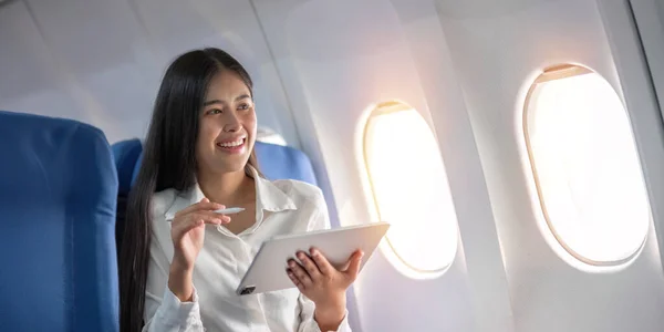 Beautiful Asian Travel Woman Watching Movie Digital Tablet Airplane — Stock Photo, Image