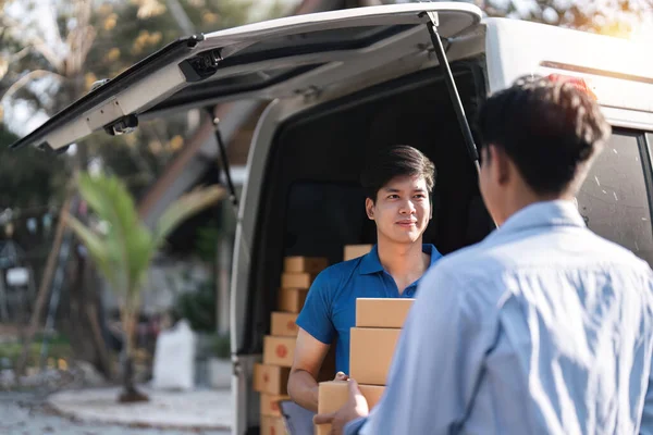 Home delivery service and working service mind. Man customer hand receiving a cardboard boxes parcel from delivery service courier. delivery logistic concept.