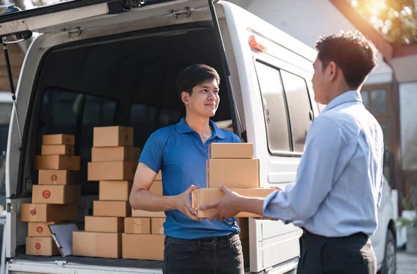 Home delivery service and working service mind. Man customer hand receiving a cardboard boxes parcel from delivery service courier. delivery logistic concept.