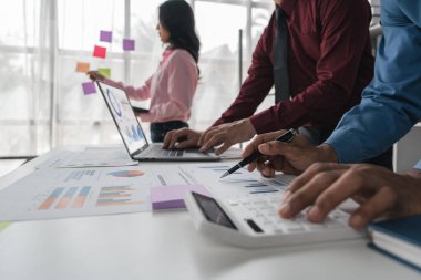 Intelligence analysis concept, group of business people brainstorm discussing current finance and economy on company investment laptop at meeting.