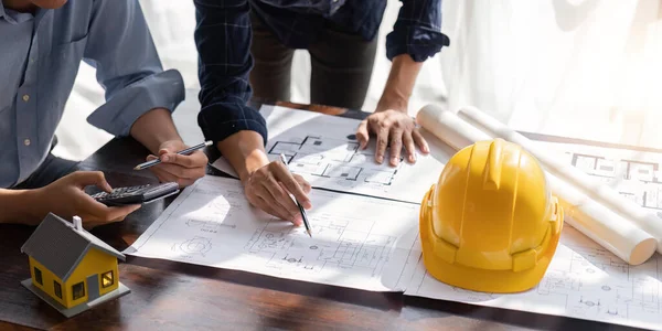 stock image engineer team planning design house, modifying plan, creating construction project and addition according to customer requirement.