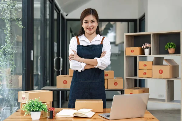 Happy asian woman work from home packaging, on line marketing packaging and delivery, SME concept.