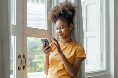 Mutlu kadın rahatlıyor, internetteki web sörfü bilgisinden zevk alıyor ya da mobil yazılım uygulaması kullanıyor, evdeki sosyal ağlardaki arkadaşlarıyla uzaktan iletişim kuruyor..