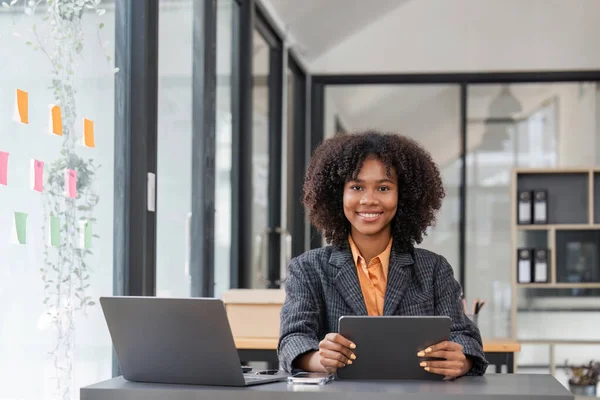 stock image Young happy business woman working with tablet in corporate office.