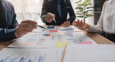 İş adamları gelir tablolarını ve grafiklerini inceliyor. Kapatın. İş analizi ve strateji kavramı.