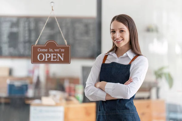 Startup successful small business owner sme beauty girl stand with tablet in coffee shop restaurant. Portrait of asian woman barista cafe owner. SME entrepreneur seller business concept.