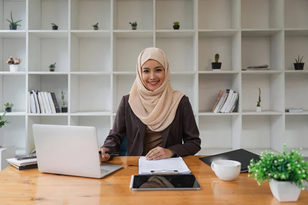 stock image Asian Muslim business woman siting in the modern office. business people, diversity and office concept.