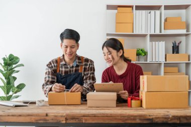 Birkaç Asyalı genç iş adamı online alışveriş için evlerinde çalışıyor, teknoloji bilgisayarı ve dizüstü bilgisayarı, girişimci ve yaşam tarzı konseptini kontrol ediyorlar..