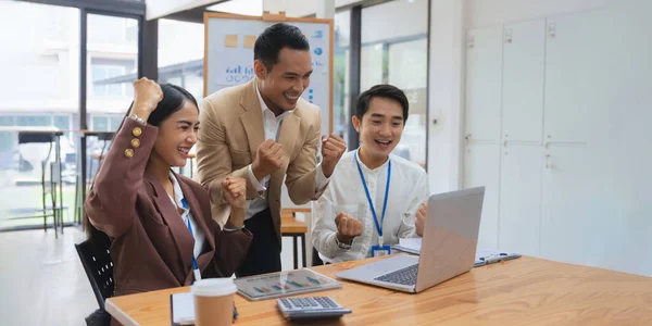 Businesspeople Asians are determined and excited about their work. Business success corporate. Asian business team smiling and arms up after success job with partner.