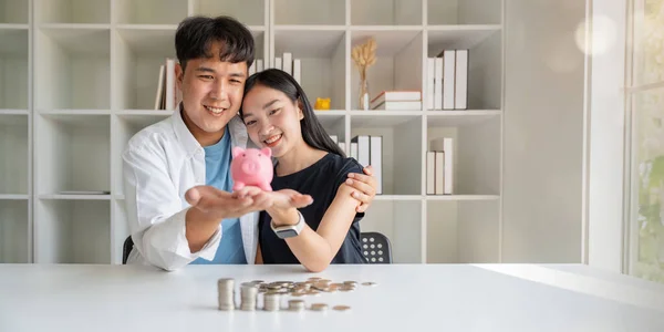 Saving money investment for future. Couple hands holding piggy bank with money . Couple asian counting saving money plan future budget. Investment banking concept.