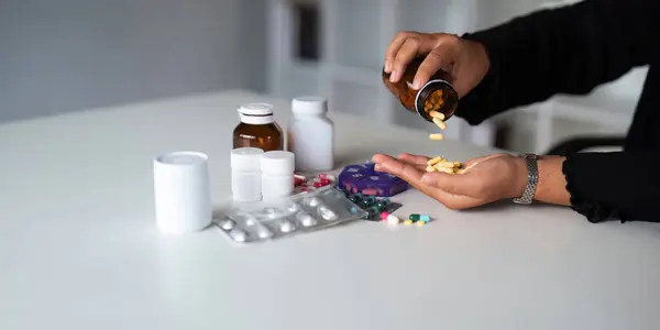 Women organize check the medicine bottle her medication into pill dispenser. female taking pills from box. Healthcare and concept with medicines. medicaments on table.