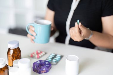 Sick illness woman hold pill on hand pouring capsules and glass take painkiller supplement medicine. Healthcare, headache, treatment, therapy concept. clipart