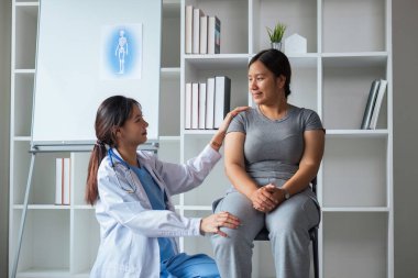 Kilolu bir kadın klinikte danışmanlık yapıyor. Dost canlısı gülümseyen doktorun portresi elini omzuna koyar, klinikte muayene sırasında konsültasyon yapar..