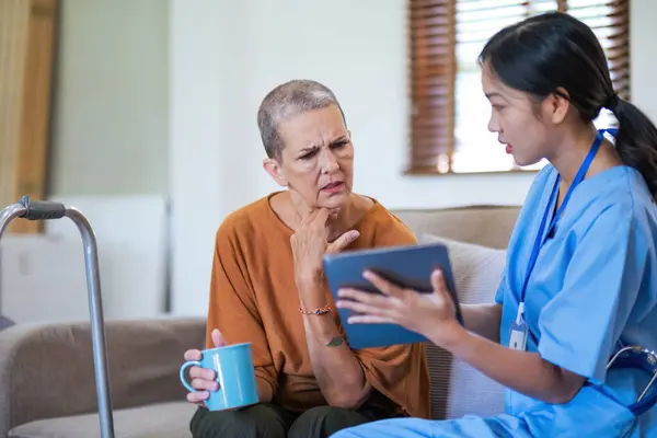 doctor video call discussion results or symptoms and gives a recommendation to a senior female patient, having constipation during medical examination in clinic.