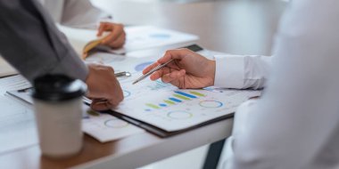 İş adamları gelir tablosunu ve grafiğini inceliyor. Kapatın. İş analizi ve strateji kavramı.