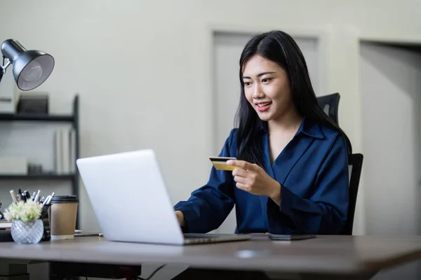 Woman on desk with laptop, credit card and ecommerce payment for online shopping at home. digital bank app and sale on store website with internet banking.