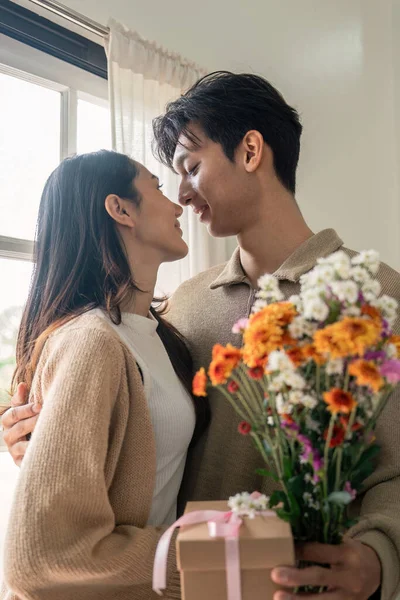 Романтична Молода Азіатська Пара Обіймається Триманням Квітів Посміхається Вітальні Вдома — стокове фото