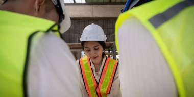 Çalışma sahasında ortaklık ve mühendislik araçları ile birlikte çalışarak proje için mühendis ya da mimar toplantısı konsepti.