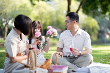 Büyükannem ve büyükbabam parkta torunumla eğleniyorlar. Birlikte neşeli ve neşeli vakit geçiriyorlar. Bir sürü gülümseme ve mutlu anlar.