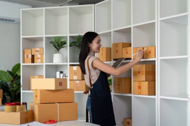 İnternetteki Asyalı kadın müşteri adresini ve müşteri siparişini kontrol et. Çevrimiçi alışveriş kavramı.