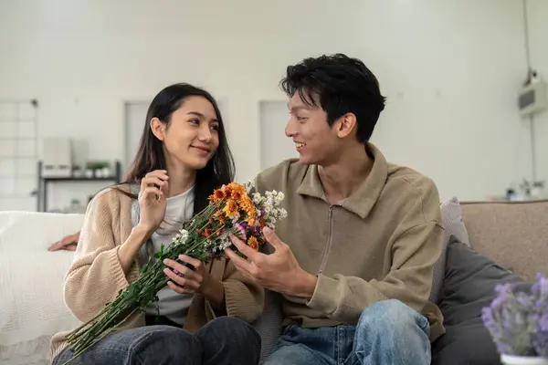 stock image Young couple enjoying flowers at home. Concept of love, companionship, and happiness.