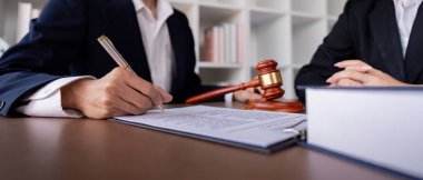 Profesyonel bir avukat, yasal anlaşma ve iş ortaklığını simgeleyen bir ofis ortamında iş sözleşmesi imzalar..