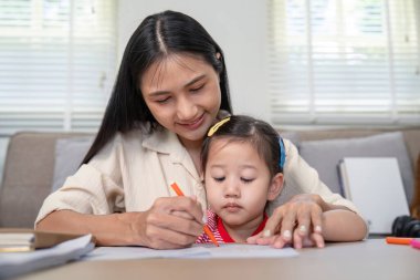 Şefkatli bir anne, kızına bir çizim aktivitesinde yardım eder. İlişkilerinde yaratıcılığı ve desteği teşvik eder..