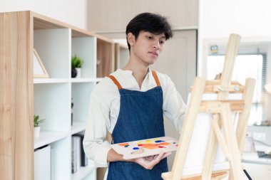 Modern bir stüdyoda canlı bir resim seansına katılan bir sanatçı yaratıcı süreci gözler önüne seriyor..