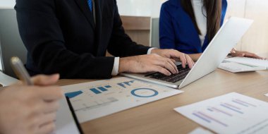 Çağdaş bir çalışma alanında veri analizi ve tartışma, takım çalışması ve profesyonellik üzerine yoğunlaşan çeşitli bir iş ekibi.