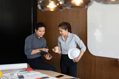 İki mühendis içkilerini paylaşırken, takım çalışmasını ve çalışma alanlarında ileri görüşlülüğü gösterirken yenilikçi çözümler üretiyor..
