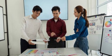 Bir atölye ortamında, ekip üyeleri aktif olarak fikirleri paylaşıyor ve çiziyor, yaklaşan bir proje için tasarım sürecini geliştiriyor, işbirliği ve yeniliğe odaklanıyor.