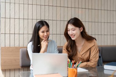 Her iki arkadaş da parlak bir atmosferde bir proje üzerinde çalışırken çığır açan bir buluşu kutlarken neşeli ifadeler..