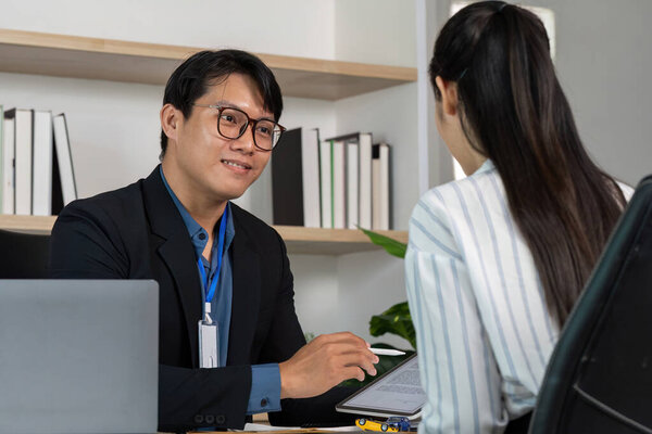 A consultant explains car insurance details to a client, highlighting the importance of understanding coverage.