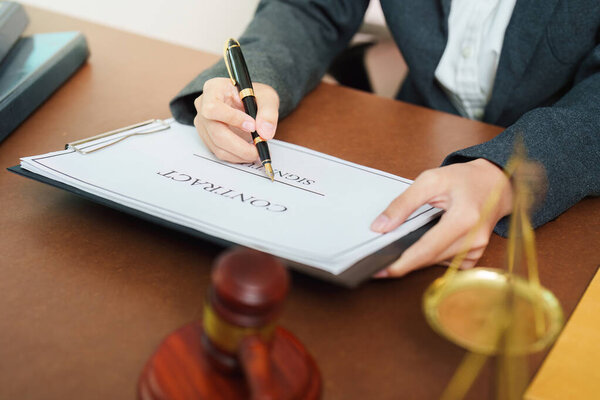A lawyer completes the signing of a contract, showcasing professionalism and attention to detail in legal matters.