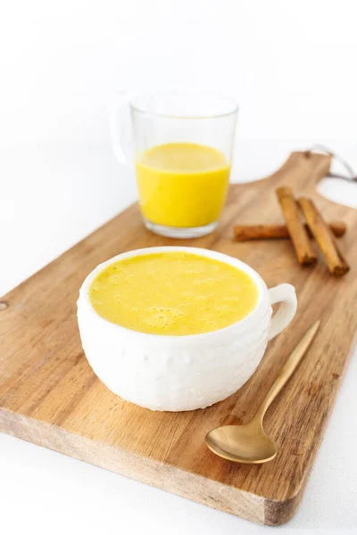 stock image Golden milk, drink made with vegetable or cow's milk and with turmeric, cinnamon and other spices. Very aromatic, healthy and tasty drink.