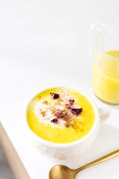 stock image Golden milk, drink made with vegetable or cow's milk and with turmeric, cinnamon and other spices. Very aromatic, healthy and tasty drink.