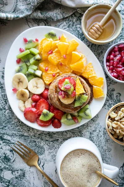 stock image Pancakes with fresh fruit. Fruit salad with gluten-free pancakes. Healthy breakfast full of vitamins