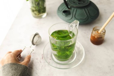 Tea with fresh mint leaves. Mint infusion helps with digestive problems